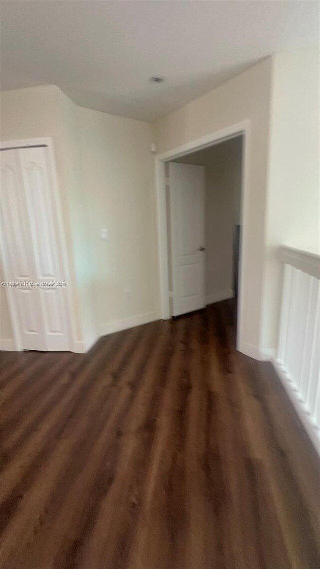 9942 SW 158th Ct, Miami, FL 33196 - empty room with dark wood finished floors and baseboards