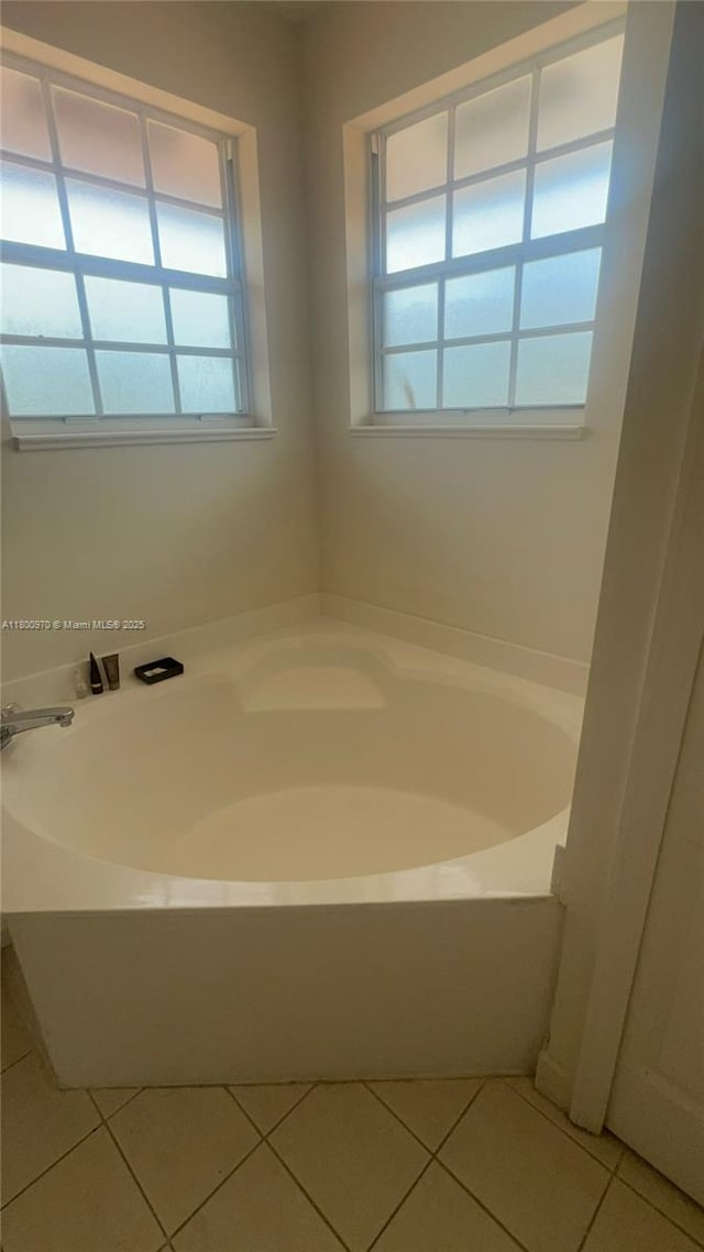 9942 SW 158th Ct, Miami, FL 33196 - bathroom with plenty of natural light, tile patterned flooring, and a garden tub