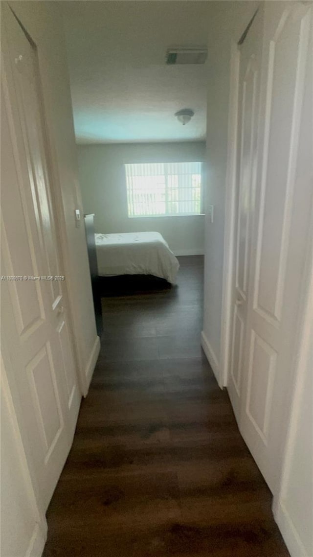 9942 SW 158th Ct, Miami, FL 33196 - corridor featuring dark wood finished floors and baseboards