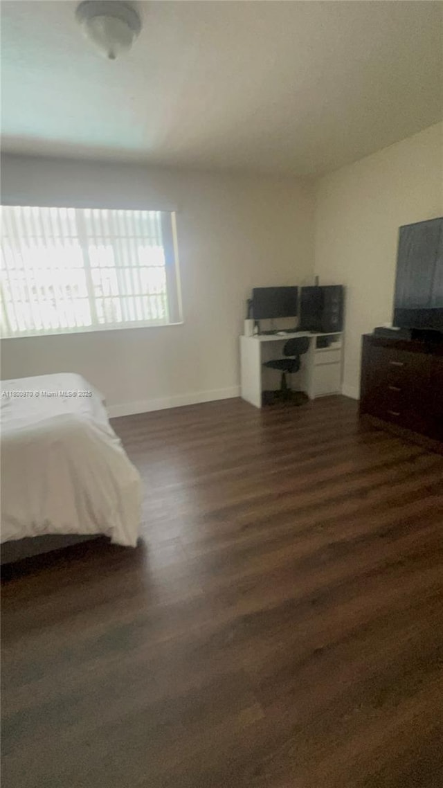9942 SW 158th Ct, Miami, FL 33196 - bedroom with wood finished floors, baseboards, and a desk