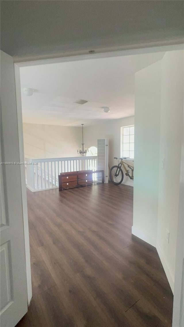 9942 SW 158th Ct, Miami, FL 33196 - hall featuring dark wood-type flooring, a chandelier, and baseboards