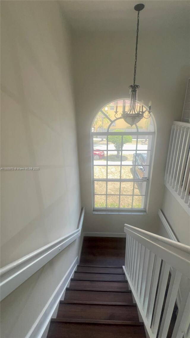 9942 SW 158th Ct, Miami, FL 33196 - stairway with a chandelier and wood finished floors