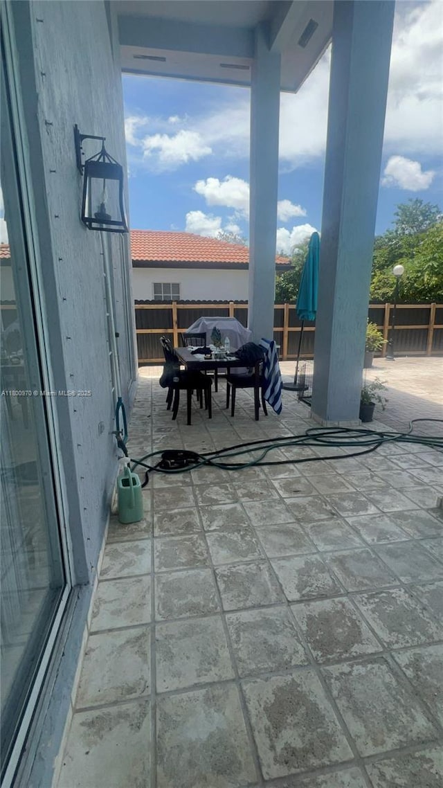 9942 SW 158th Ct, Miami, FL 33196 - view of patio featuring a fenced backyard and outdoor dining area