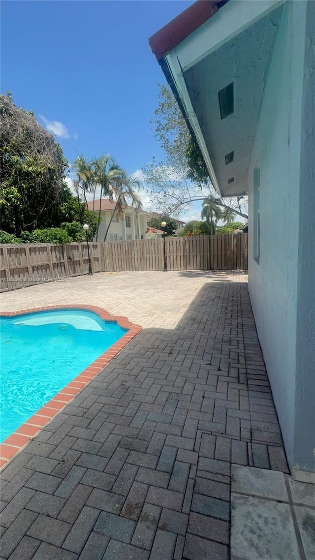 9942 SW 158th Ct, Miami, FL 33196 - view of swimming pool featuring a fenced backyard and a patio