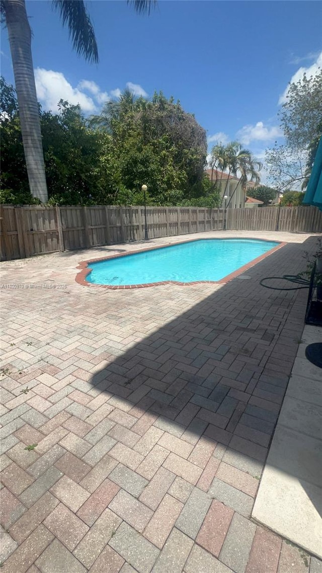 9942 SW 158th Ct, Miami, FL 33196 - view of swimming pool featuring a patio and a fenced backyard