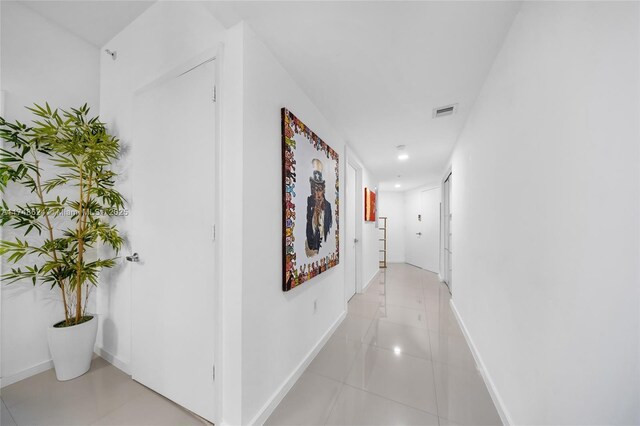 3030 NE 188th St Unit 602, Aventura, FL 33180 - hallway with light tile patterned floors, baseboards, and recessed lighting