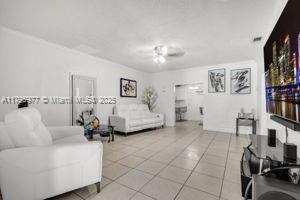 3275 NW 95th St, Miami, FL 33147 - living room with light tile patterned floors