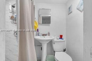 3275 NW 95th St, Miami, FL 33147 - bathroom featuring toilet and a shower with curtain