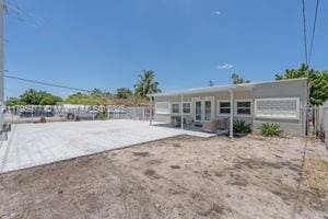 3275 NW 95th St, Miami, FL 33147 - rear view of property with fence and a patio