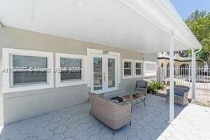 3275 NW 95th St, Miami, FL 33147 - view of patio with french doors and fence
