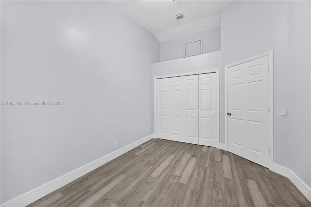 3639 NW 83rd Ln, Sunrise, FL 33351 - unfurnished bedroom with wood finished floors, baseboards, a towering ceiling, and a closet