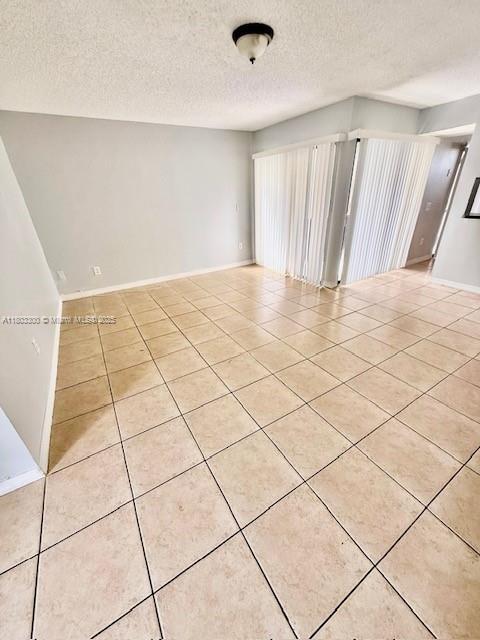 1100 Constitution Dr Unit 1100G, Homestead, FL 33034 - unfurnished room featuring light tile patterned floors and a textured ceiling