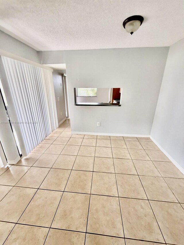 1100 Constitution Dr Unit 1100G, Homestead, FL 33034 - spare room with a textured ceiling and light tile patterned flooring