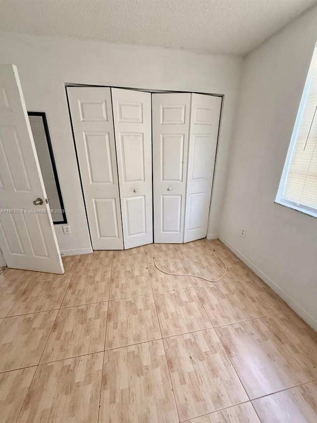 1100 Constitution Dr Unit 1100G, Homestead, FL 33034 - unfurnished bedroom with a closet and a textured ceiling