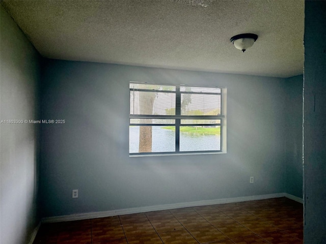 1100 Constitution Dr Unit 1100G, Homestead, FL 33034 - empty room featuring a textured ceiling and baseboards