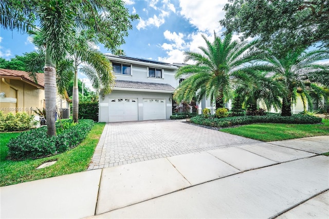 18201 NW 16th St, Pembroke Pines, FL 33029 - view of front of house with an attached garage, driveway, stucco siding, a tiled roof, and central air condition unit