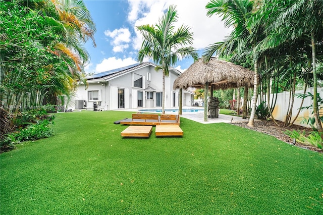 18201 NW 16th St, Pembroke Pines, FL 33029 - back of house featuring stucco siding, a gazebo, central AC, a deck, and solar panels