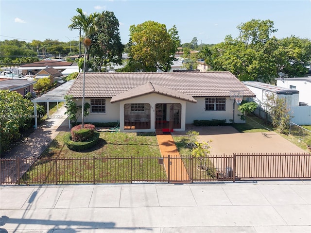 9210 SW 41st St, Miami, FL 33165 - view of front of house featuring a tile roof, a fenced front yard, and stucco siding
