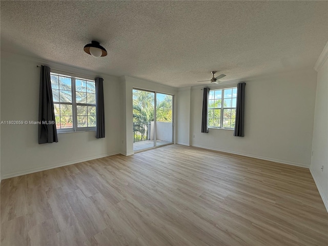 616 Clearwater Park Rd Unit 212, West Palm Beach, FL 33401 - spare room featuring plenty of natural light, a textured ceiling, light wood-style floors, ceiling fan, and baseboards