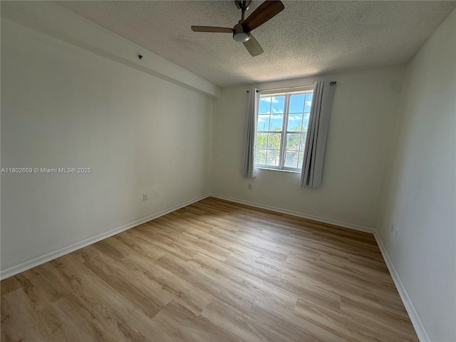 616 Clearwater Park Rd Unit 212, West Palm Beach, FL 33401 - unfurnished room with a textured ceiling, ceiling fan, light wood-style flooring, and baseboards