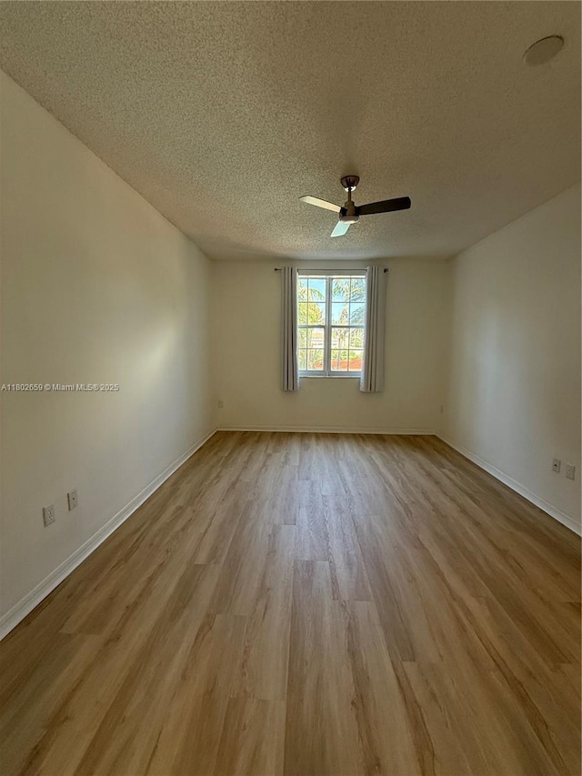 616 Clearwater Park Rd Unit 212, West Palm Beach, FL 33401 - spare room with a textured ceiling, ceiling fan, wood finished floors, and baseboards