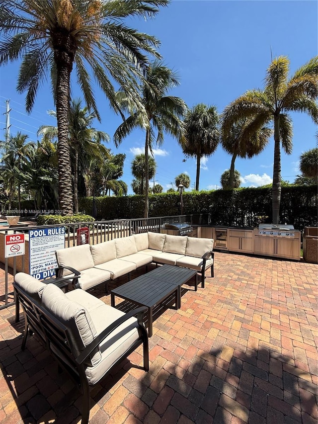 616 Clearwater Park Rd Unit 212, West Palm Beach, FL 33401 - view of patio / terrace with an outdoor living space, exterior kitchen, fence, and area for grilling