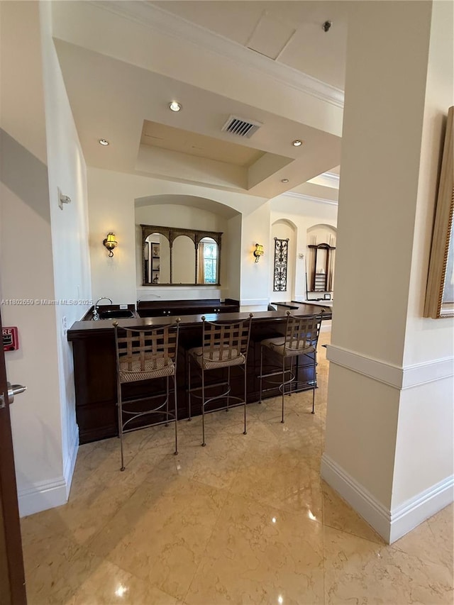 616 Clearwater Park Rd Unit 212, West Palm Beach, FL 33401 - bar with marble tiled floors, baseboards, a raised ceiling, recessed lighting, and crown molding
