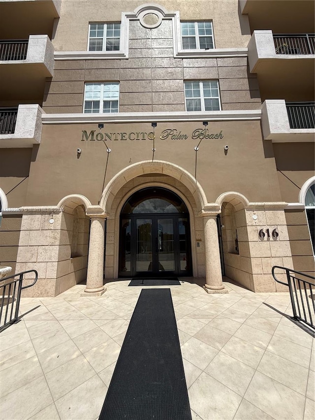 616 Clearwater Park Rd Unit 212, West Palm Beach, FL 33401 - view of exterior entry with french doors and stucco siding