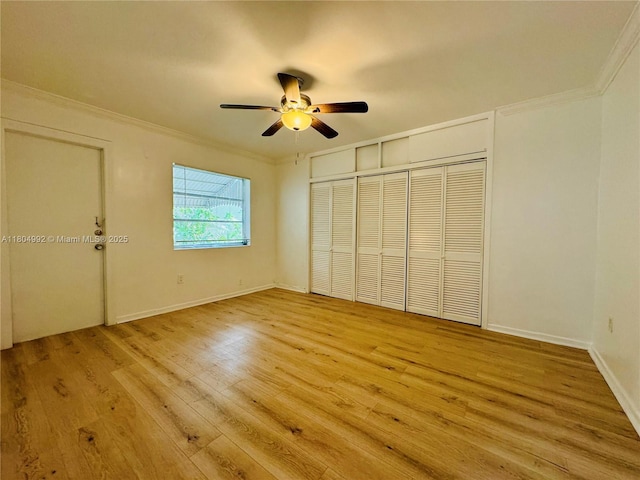 65 Washington Ave Unit 3, Miami Beach, FL 33139 - unfurnished bedroom with light wood-style flooring, crown molding, a closet, ceiling fan, and baseboards
