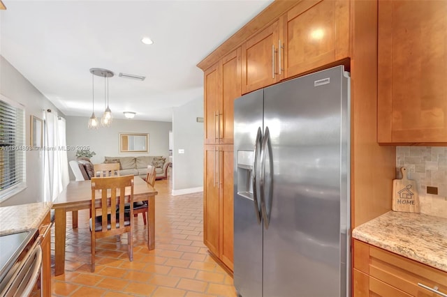11955 Brim Way, Cooper City, FL 33026 - kitchen with appliances with stainless steel finishes, backsplash, light stone counters, light tile patterned floors, and brown cabinets
