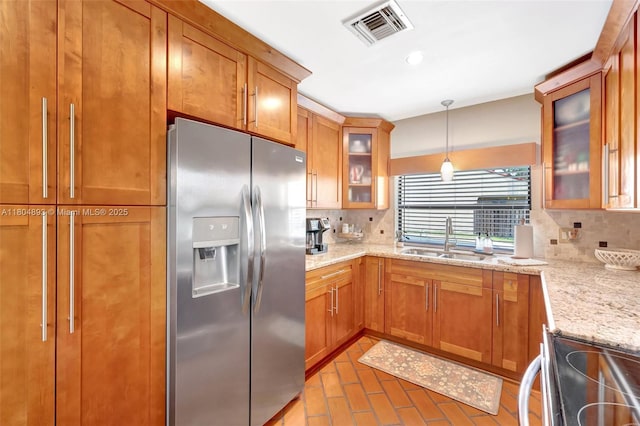 11955 Brim Way, Cooper City, FL 33026 - kitchen featuring stainless steel fridge, electric stove, tasteful backsplash, brick flooring, and brown cabinets