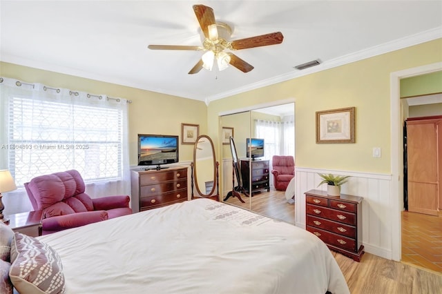 11955 Brim Way, Cooper City, FL 33026 - bedroom with a closet, a wainscoted wall, crown molding, light wood-type flooring, and ceiling fan