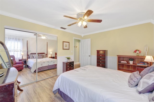 11955 Brim Way, Cooper City, FL 33026 - bedroom featuring wood finished floors, ornamental molding, a wainscoted wall, a closet, and a ceiling fan