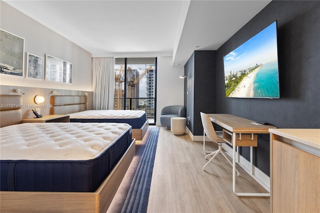 601 NE 1st Ave Unit 2004, Miami, FL 33132 - bedroom with wood finished floors, baseboards, and floor to ceiling windows