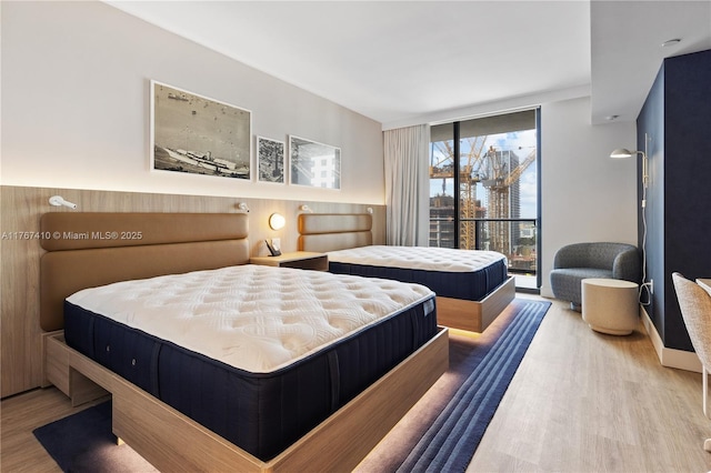 601 NE 1st Ave Unit 2004, Miami, FL 33132 - bedroom featuring wood finished floors, access to exterior, and a wall of windows