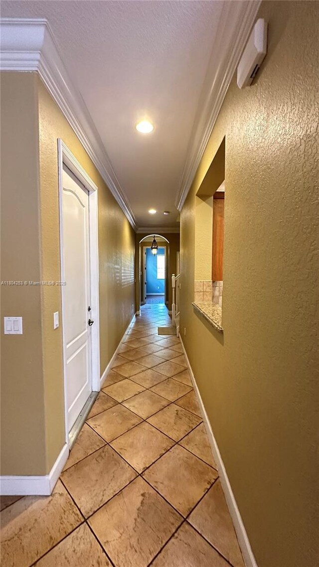 8716 Blaze Ct, Davie, FL 33328 - hall featuring ornamental molding, arched walkways, light tile patterned flooring, baseboards, and recessed lighting