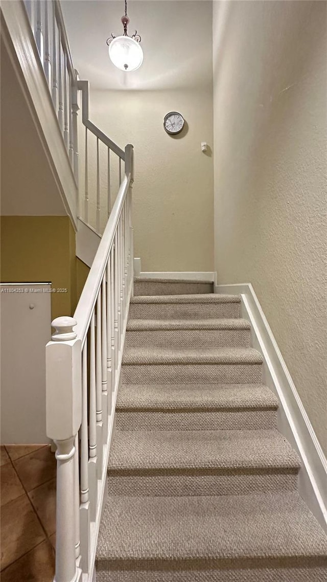 8716 Blaze Ct, Davie, FL 33328 - staircase featuring tile patterned floors and a textured wall