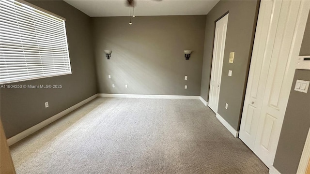 8716 Blaze Ct, Davie, FL 33328 - spare room with baseboards, light carpet, and ceiling fan