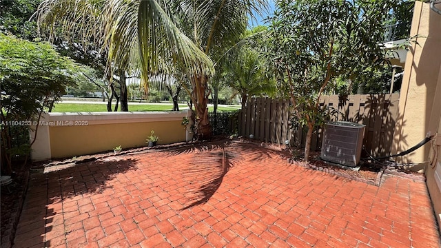 8716 Blaze Ct, Davie, FL 33328 - view of patio / terrace with central AC and fence
