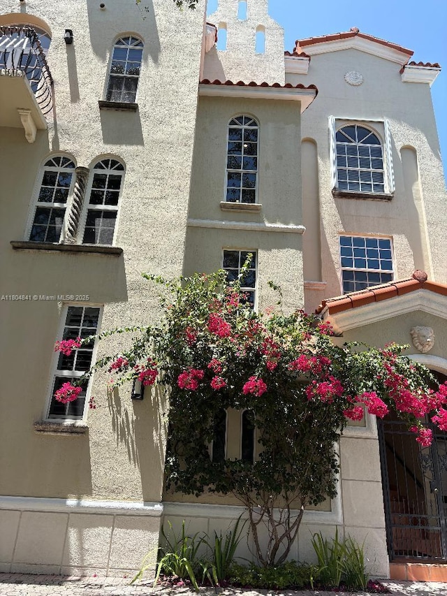 view of front of home featuring stucco siding and a tiled roof