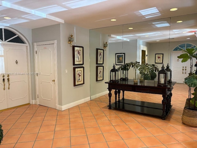 entrance foyer with light tile patterned flooring, recessed lighting, and baseboards
