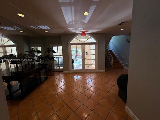 entryway featuring baseboards, tile patterned flooring, stairs, and french doors