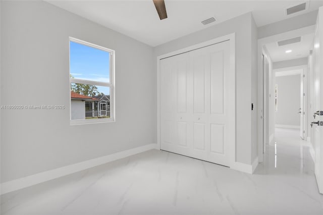 418 8th Ave, Lehigh Acres, FL 33972 - unfurnished bedroom with marble finish flooring, baseboards, a closet, a ceiling fan, and recessed lighting
