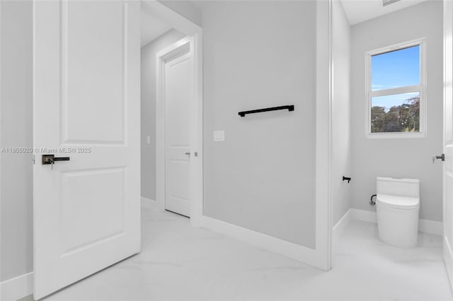 418 8th Ave, Lehigh Acres, FL 33972 - bathroom featuring marble look tile flooring, baseboards, and toilet