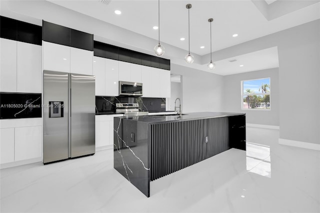 418 8th Ave, Lehigh Acres, FL 33972 - kitchen featuring appliances with stainless steel finishes, a sink, white cabinets, backsplash, and modern cabinets