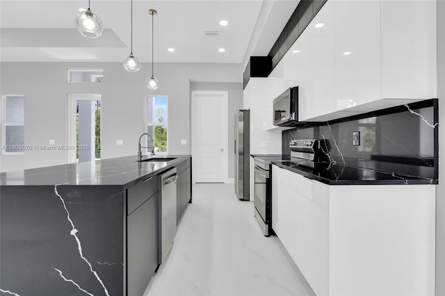 418 8th Ave, Lehigh Acres, FL 33972 - kitchen featuring appliances with stainless steel finishes, a sink, modern cabinets, white cabinetry, and recessed lighting