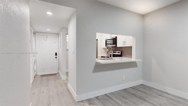 15805 W Waterside Cir Unit 202, Sunrise, FL 33326 - hallway with light wood-style floors, baseboards, recessed lighting, and a sink