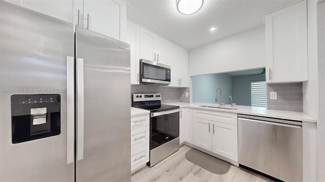 15805 W Waterside Cir Unit 202, Sunrise, FL 33326 - kitchen with stainless steel appliances, a sink, light countertops, white cabinets, and recessed lighting