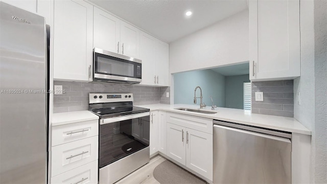 15805 W Waterside Cir Unit 202, Sunrise, FL 33326 - kitchen with appliances with stainless steel finishes, a sink, backsplash, light countertops, and white cabinetry