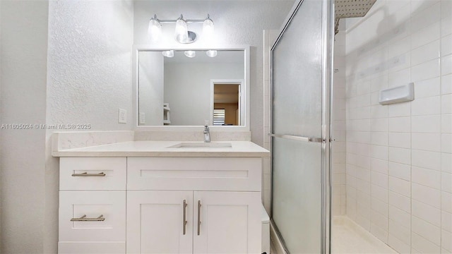 15805 W Waterside Cir Unit 202, Sunrise, FL 33326 - full bath with a stall shower, a textured wall, and vanity